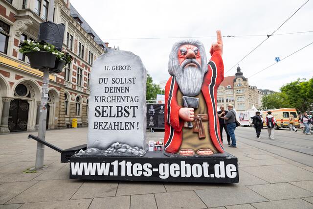 Kritische Installation mit Moses-Figur und Gesetztestafel mit 11. Gebot "Du sollst deinen Kirchentag selbst bezahlen!" | Foto: Foto: epd-bild/Paul-Philipp Braun